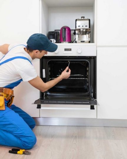 man repairing oven - About North Charleston Appliance Repair Pros - Oven Repair North Charleston